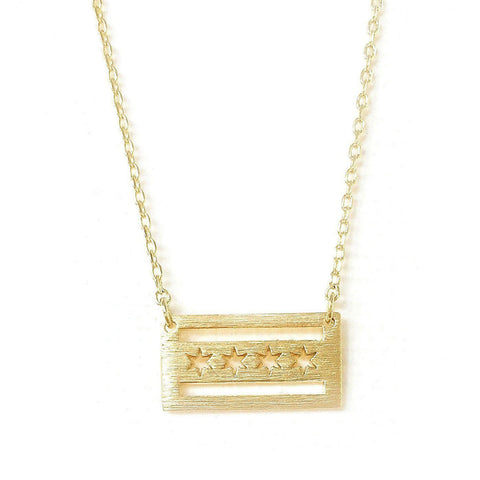 A gold-colored necklace featuring a pendant shaped like the Chicago flag with a brushed texture.