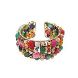 A colorful beaded cuff bracelet made from layers of Kantha beads with gold accents, displayed against a white background.