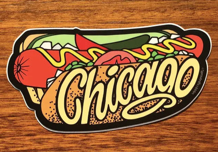 Sticker of a Chicago-style hot dog with text on a wooden surface