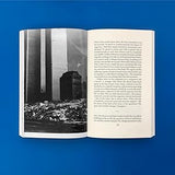 Open book with black and white photograph and text on a blue background