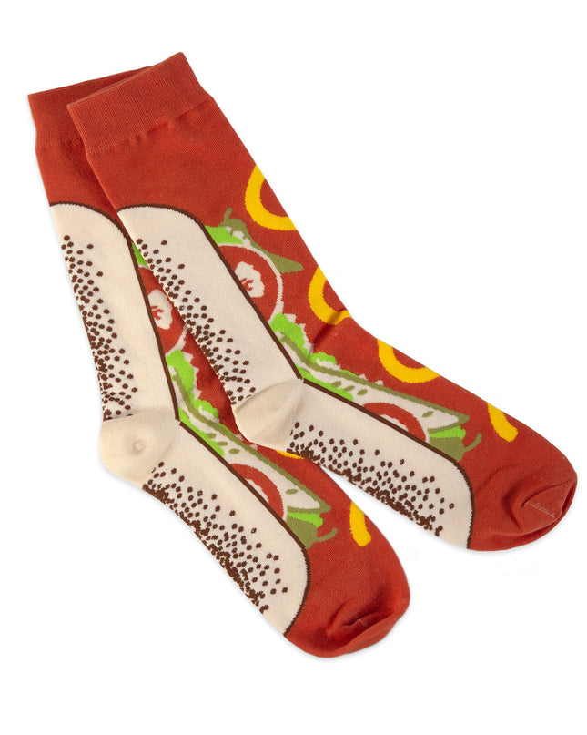 A pair of red socks with a Chicago-style hot dog design, featuring mustard, relish, onions, and tomatoes.