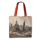 A tote bag with a white fabric featuring a detailed illustration of a city skyline and red ribbed straps.